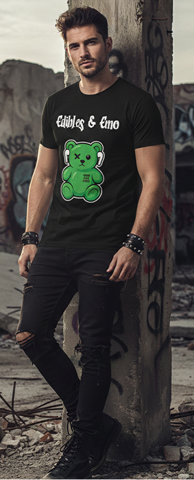 Man wearing a black t-shirt with a green bear graphic and text, standing against a graffiti-covered wall.